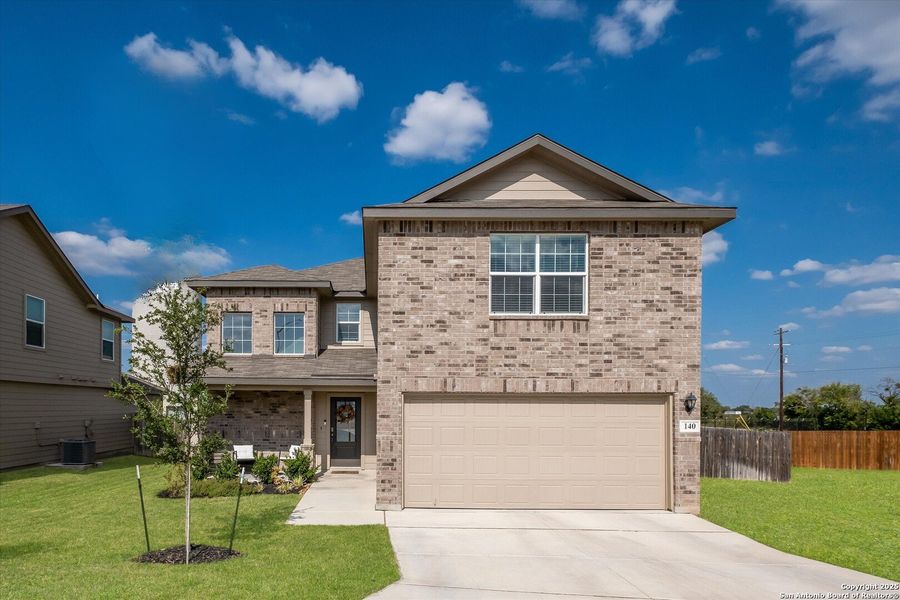 Front exterior of a new home in Red River Ranch, Cibolo, TX, highlighting curb appeal (Image 2). Front exterior of a new home in Red River Ranch, Cibolo, TX, highlighting curb appeal (Image 2).