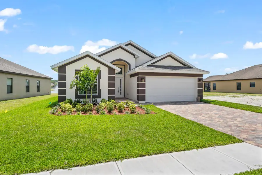 Front exterior of a new home in , Palm Bay, FL, highlighting curb appeal (Image 2).