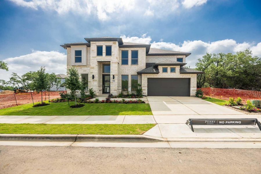 Prairie-style house featuring stone siding, an attached garage, concrete driveway, and brick siding Prairie-style house featuring stone siding, an attached garage, concrete driveway, and brick siding