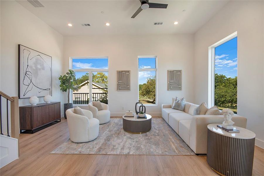 Living room featuring light wood finished floors, recessed lighting, and ceiling fan Living room featuring light wood finished floors, recessed lighting, and ceiling fan