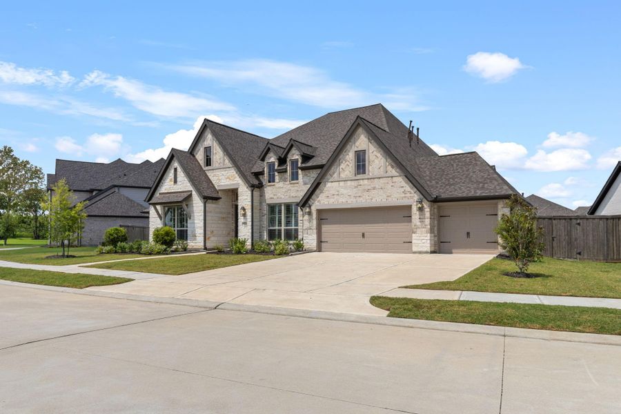 Front exterior of a new home in Riceland 70', Mont Belvieu, TX, highlighting curb appeal (Image 25).