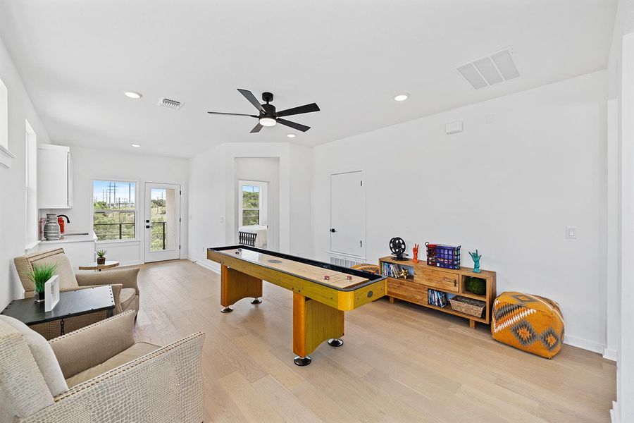 Upstairs Rec room or flex space with light wood finished floors, recessed lighting, and ceiling fan