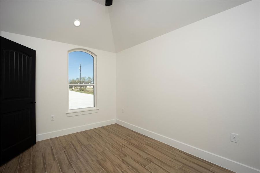 Unfurnished bedroom featuring wood tiled floors and recessed lighting