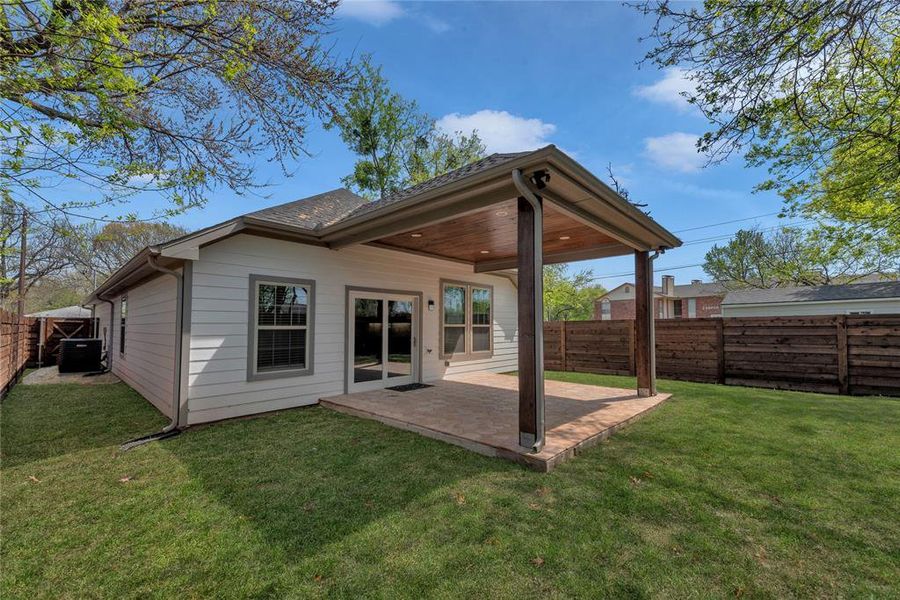 Backyard with privacy fence and covered patio
