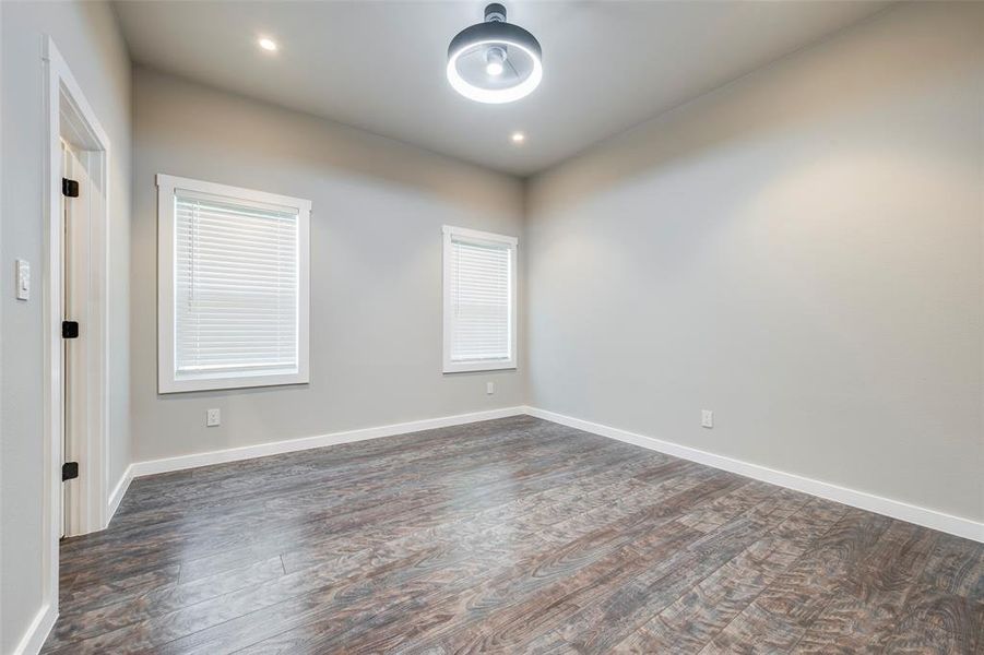 Spare room with dark wood-style flooring and recessed lighting