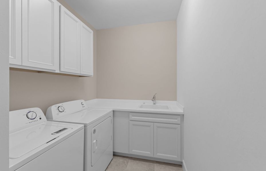 Laundry room with cabinets for added storage