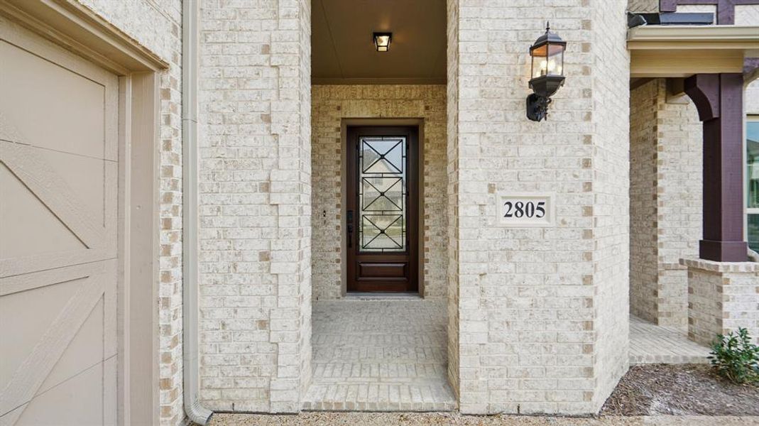 Property entrance with brick siding Property entrance with brick siding
