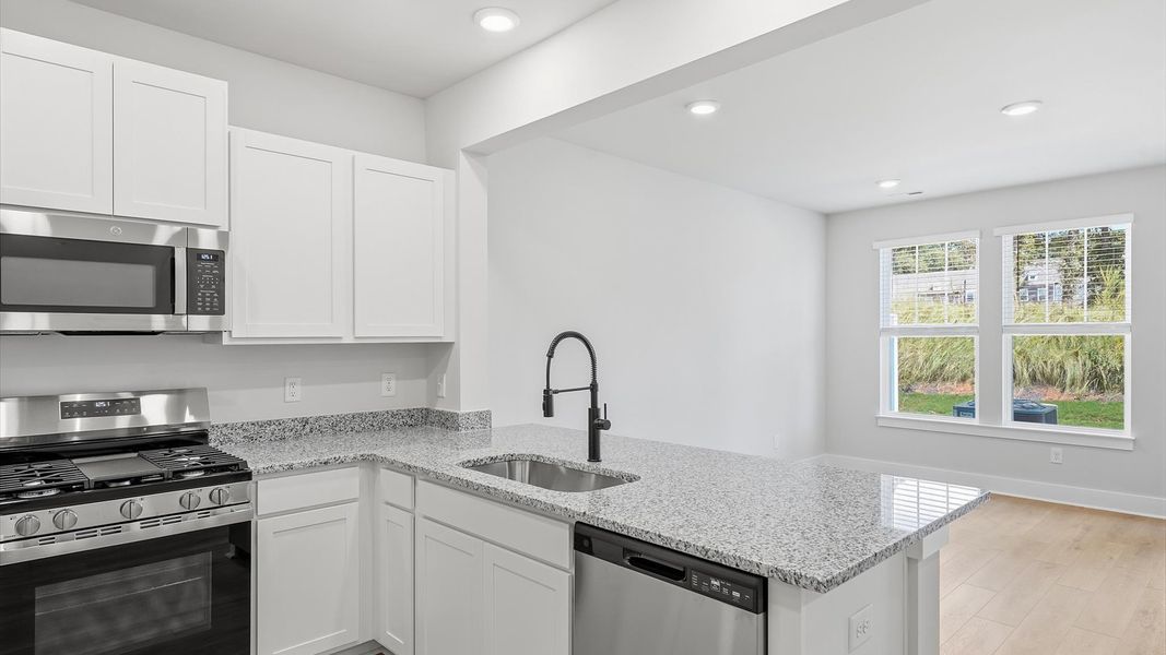 Memorable meals begin in this vibrant kitchen with granite countertops and open sightlines in Anderson, SC Memorable meals begin in this vibrant kitchen with granite countertops and open sightlines in Anderson, SC