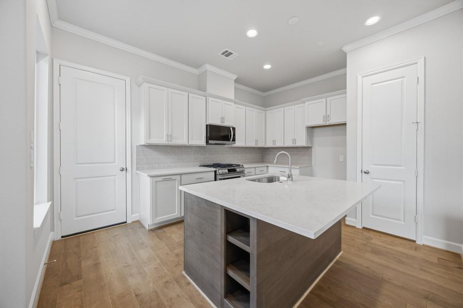 Discover a kitchen where functionality meets style, featuring an island with open shelves perfect for displaying your culinary treasures.