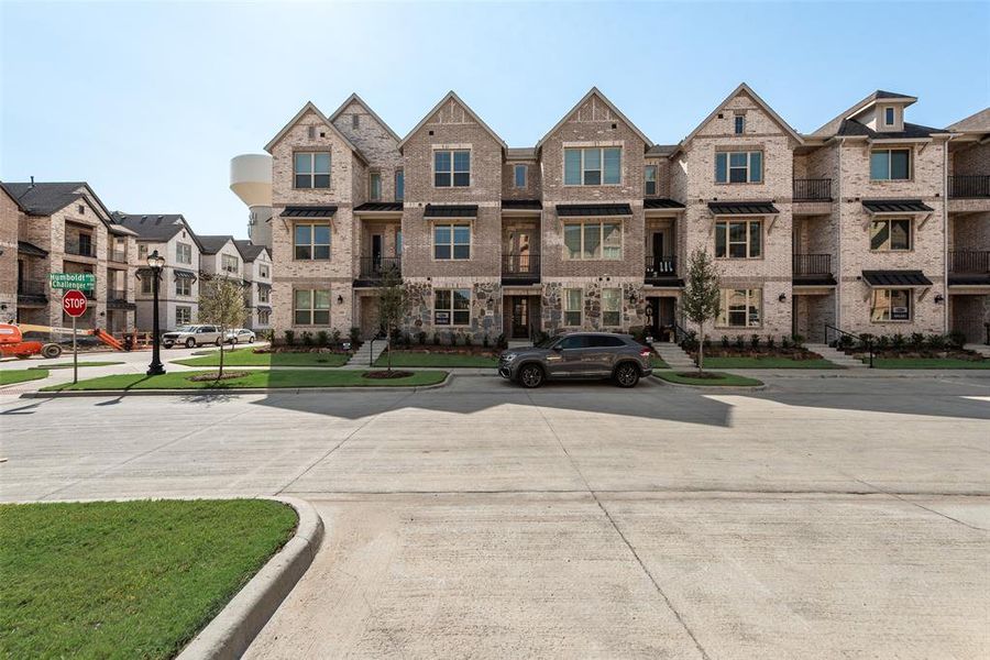 Front exterior of a new home in Wade Settlement Townhomes, Frisco, TX, highlighting curb appeal (Image 17). Front exterior of a new home in Wade Settlement Townhomes, Frisco, TX, highlighting curb appeal (Image 17).