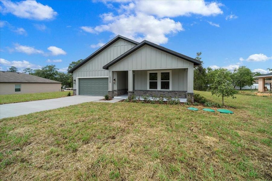 Front exterior of a new home in , Weeki Wachee, FL, highlighting curb appeal (Image 27). Front exterior of a new home in , Weeki Wachee, FL, highlighting curb appeal (Image 27).