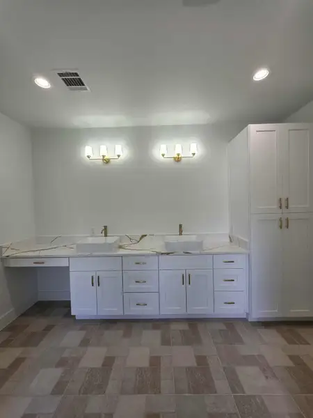 Full bathroom featuring recessed lighting and double vanity