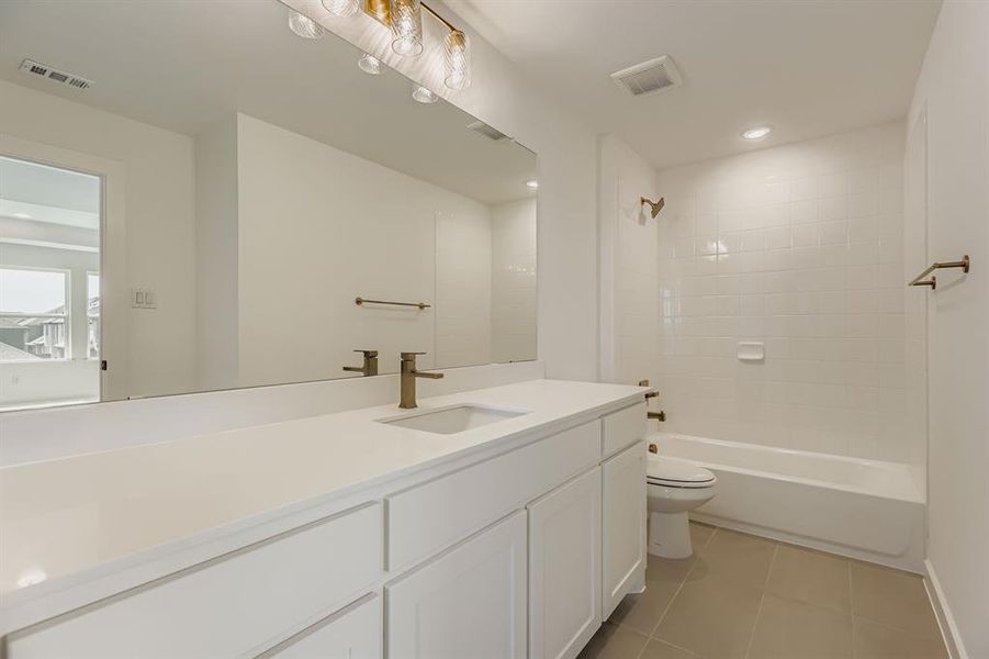Bathroom with vanity, tile patterned floors,  shower combination, and recessed lighting