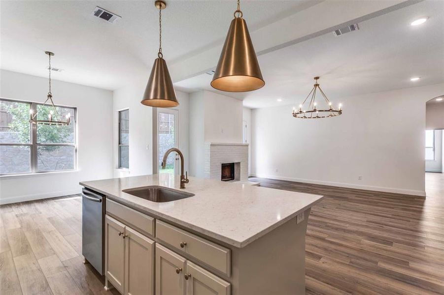 Kitchen with a sink, a chandelier, open floor plan, dishwasher, and plenty of natural light Kitchen with a sink, a chandelier, open floor plan, dishwasher, and plenty of natural light