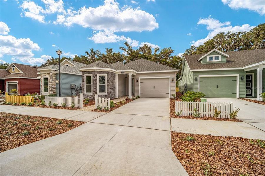 Front exterior of a new home in Fairway Pointe at West End, Newberry, FL, highlighting curb appeal (Image 22).