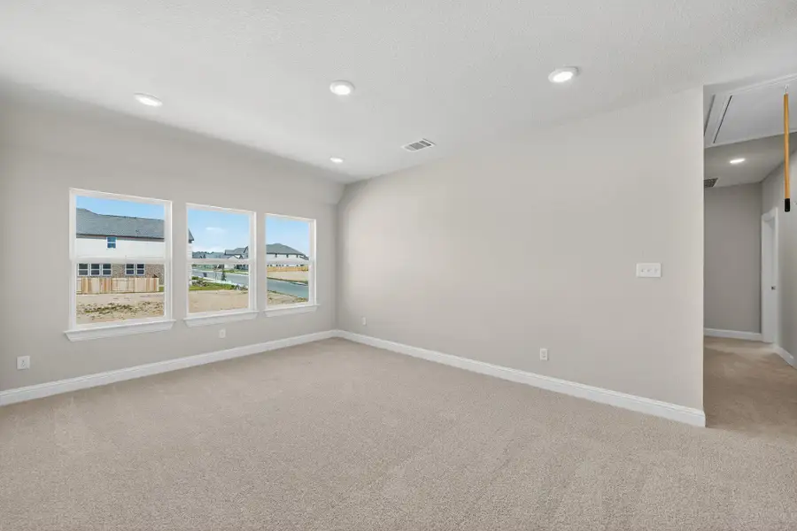 Spare room with attic access, light carpet, a textured ceiling, and recessed lighting Spare room with attic access, light carpet, a textured ceiling, and recessed lighting