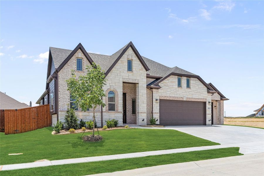 Two-story home with light stone exterior, two-car garage, and manicured front lawn Two-story home with light stone exterior, two-car garage, and manicured front lawn