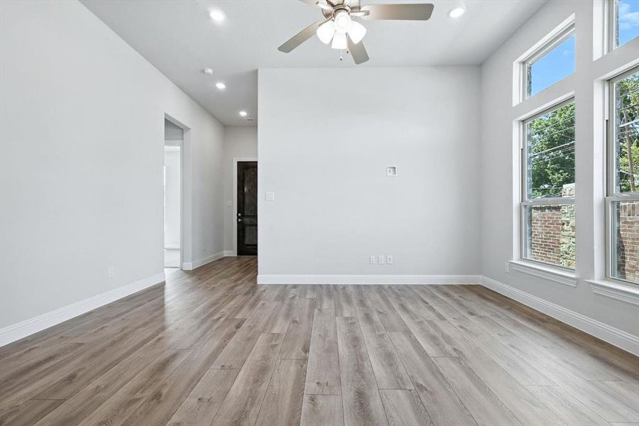 Unfurnished room featuring recessed lighting, light wood-style flooring, and a ceiling fan Unfurnished room featuring recessed lighting, light wood-style flooring, and a ceiling fan
