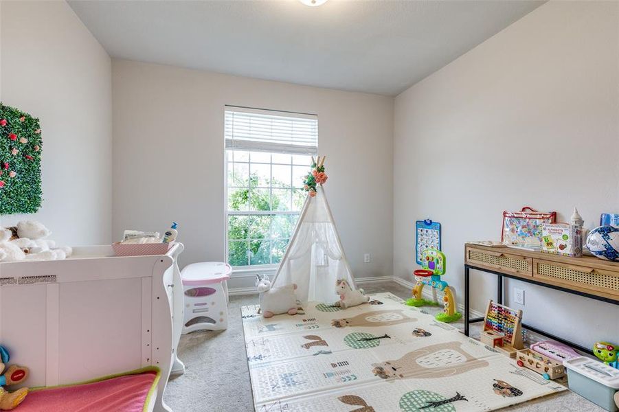 Bedroom featuring light colored carpet