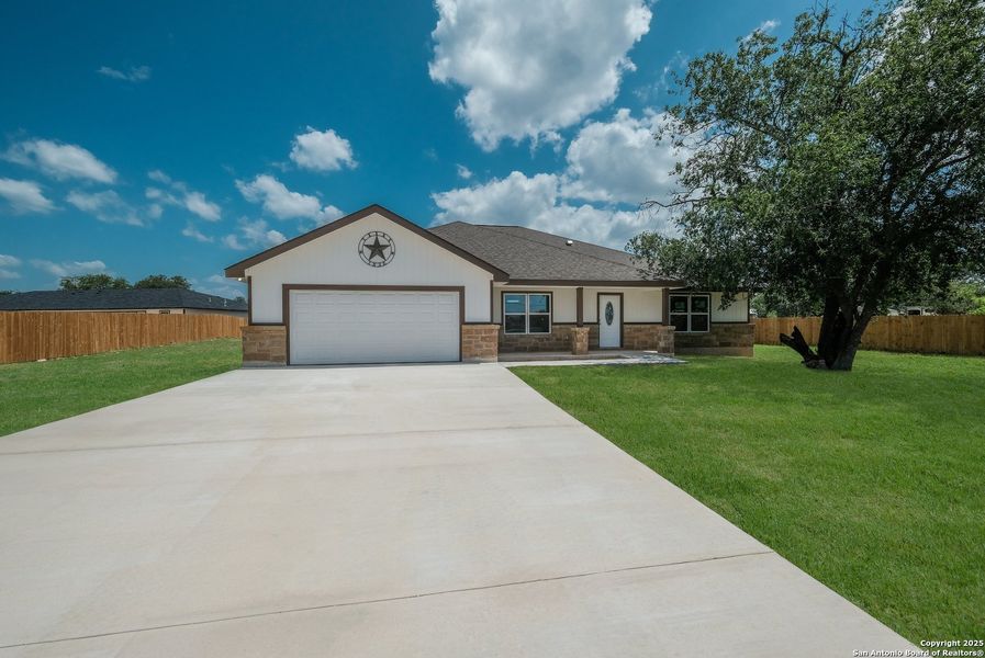 Front exterior of a new home in , Castroville, TX, highlighting curb appeal (Image 1). Front exterior of a new home in , Castroville, TX, highlighting curb appeal (Image 1).
