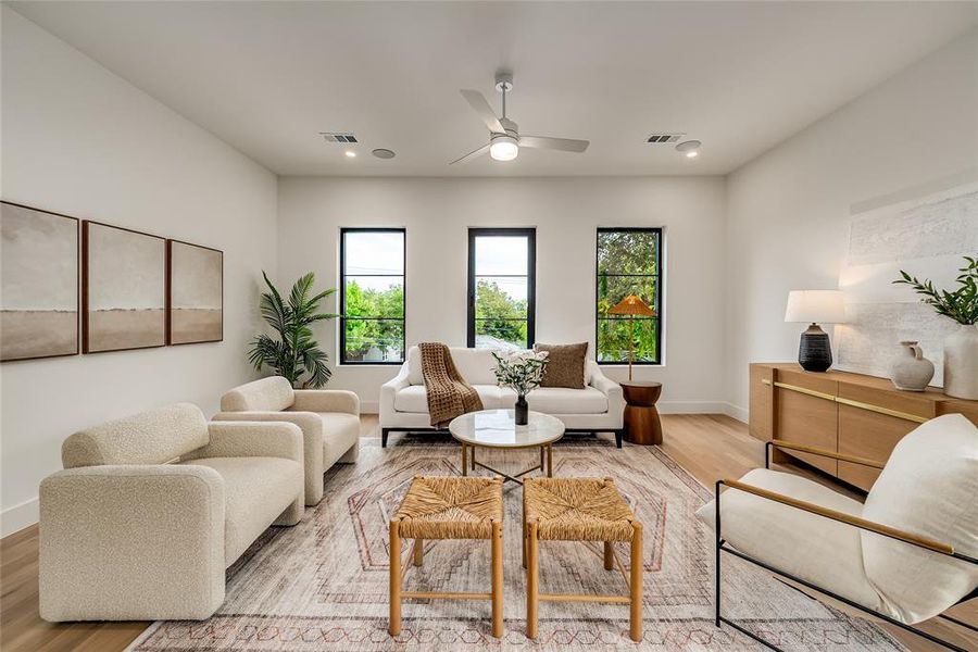 Living area featuring wood finished floors, recessed lighting, and a ceiling fan Living area featuring wood finished floors, recessed lighting, and a ceiling fan