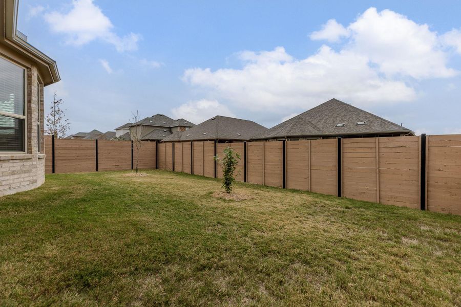 A fully fenced backyard provides privacy and a secure space for outdoor enjoyment.