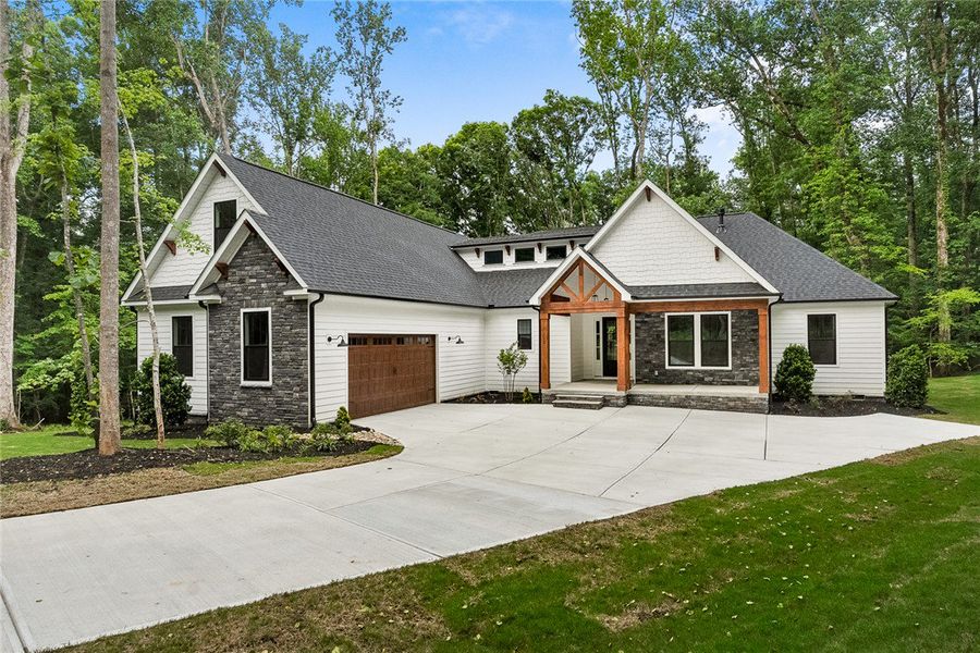 A striking blend of wood, stone, and white siding A striking blend of wood, stone, and white siding