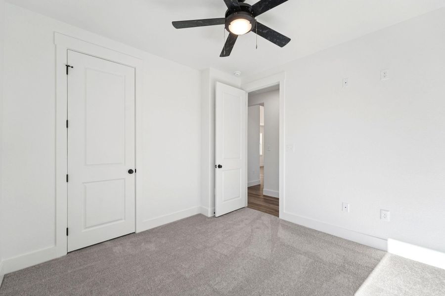 Unfurnished bedroom featuring carpet and a ceiling fan