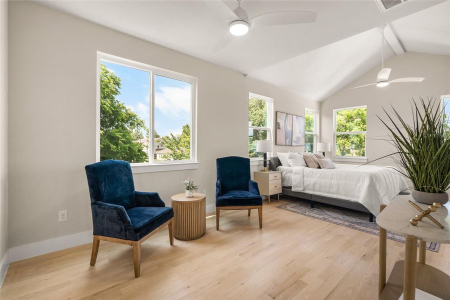 The primary suite includes a cozy sitting area that's perfect for unwinding with a book or morning coffee, leading seamlessly into the spa-inspired ensuite bath.