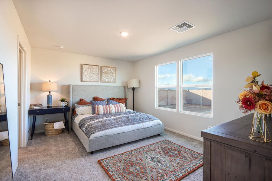 A bedroom with a large window.