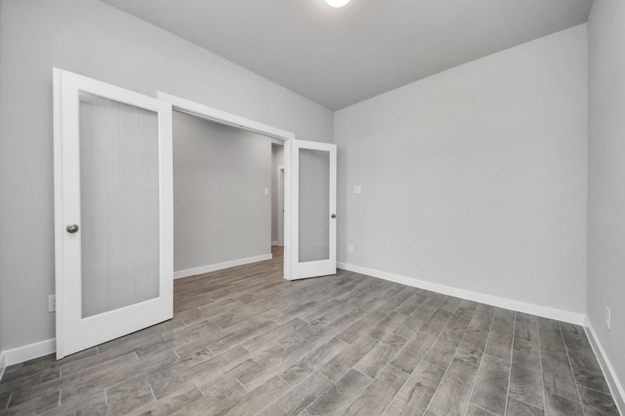 Step into the inviting home office, where elegant tile flooring adds a touch of freshnessand comfort to the workspace. Natural light pours through the window, creating aninspiring environment for productivity and focus.