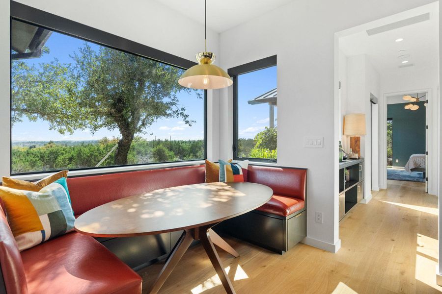 Integrated dining nook featuring built-in banquette seating with a panoramic window