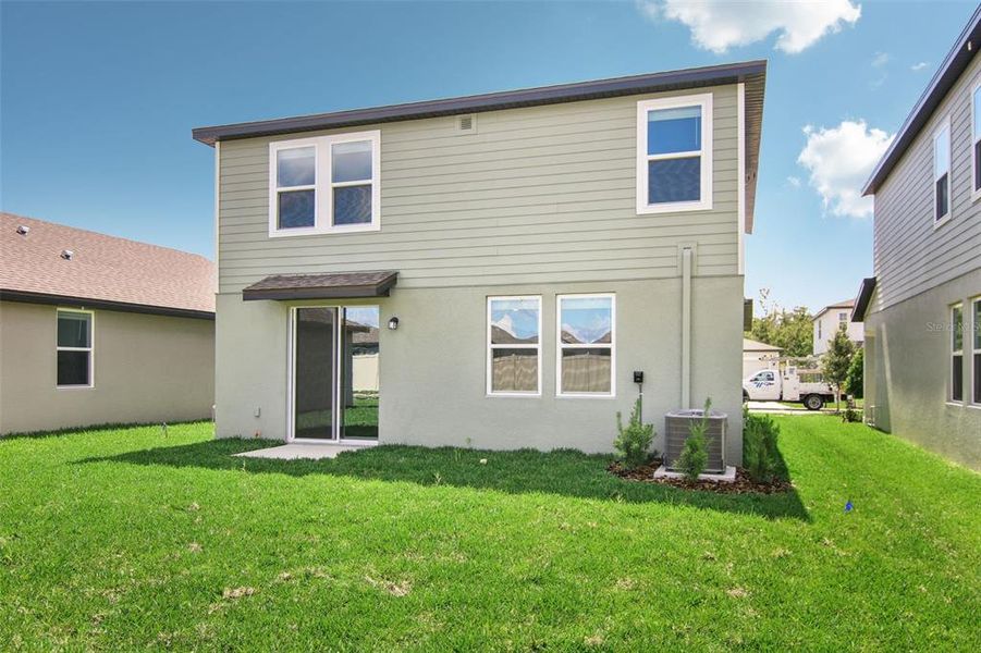 Front exterior of a new home in Two Rivers - Premier Series, Zephyrhills, FL, highlighting curb appeal (Image 11). Front exterior of a new home in Two Rivers - Premier Series, Zephyrhills, FL, highlighting curb appeal (Image 11).