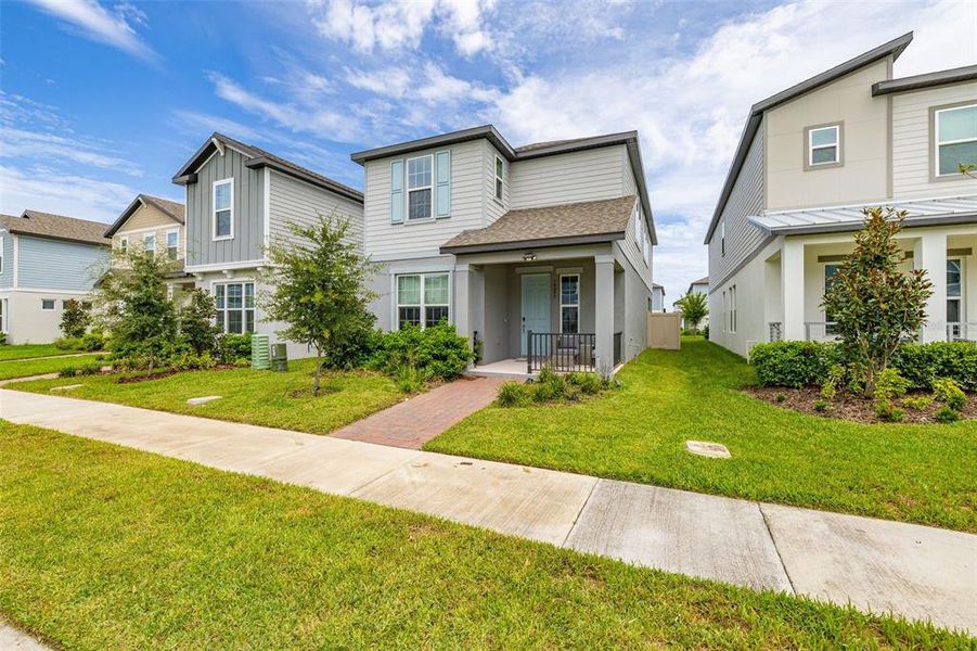 Front exterior of a new home in Highland Ridge, Winter Garden, FL, highlighting curb appeal (Image 24).