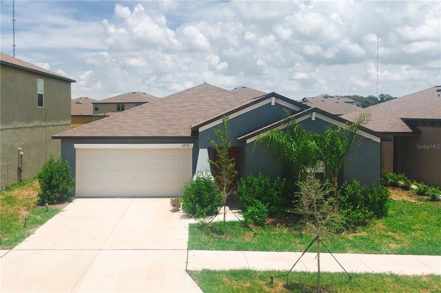 Front exterior of a new home in Triple Creek: The Estates II, Riverview, FL, highlighting curb appeal (Image 2). Front exterior of a new home in Triple Creek: The Estates II, Riverview, FL, highlighting curb appeal (Image 2).