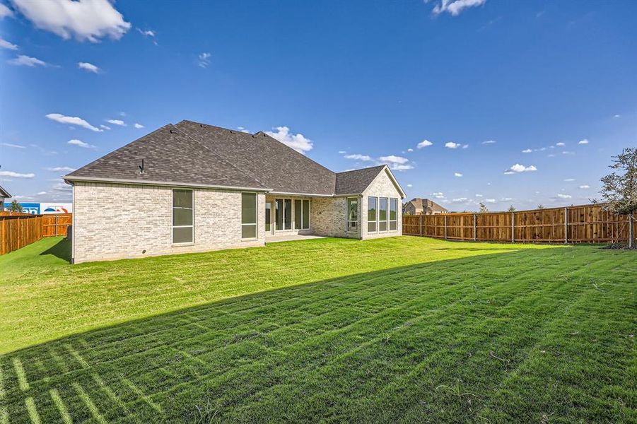 Rear view of house with a lawn