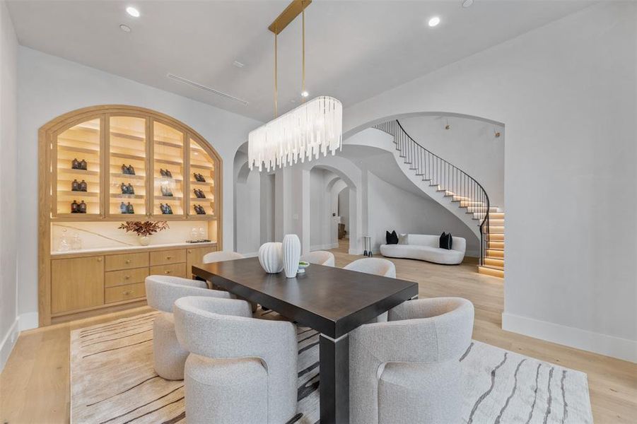 Custom wine display highlights the formal dining space with a quartz backsplash and soft-close drawers.