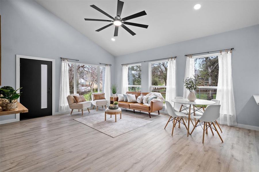 Living area featuring recessed lighting, ceiling fan, light wood-type flooring, and lofted ceiling Living area featuring recessed lighting, ceiling fan, light wood-type flooring, and lofted ceiling
