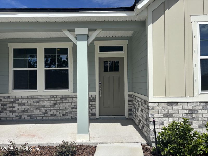 Front exterior of a new home in The Cypress Series at Reserve East, Flagler Beach, FL, highlighting curb appeal (Image 18).