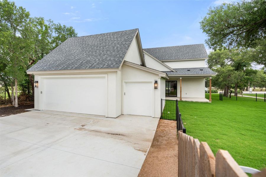 A newly constructed residence boasts an attached garage with ample parking space and a well-maintained lawn. A newly constructed residence boasts an attached garage with ample parking space and a well-maintained lawn.