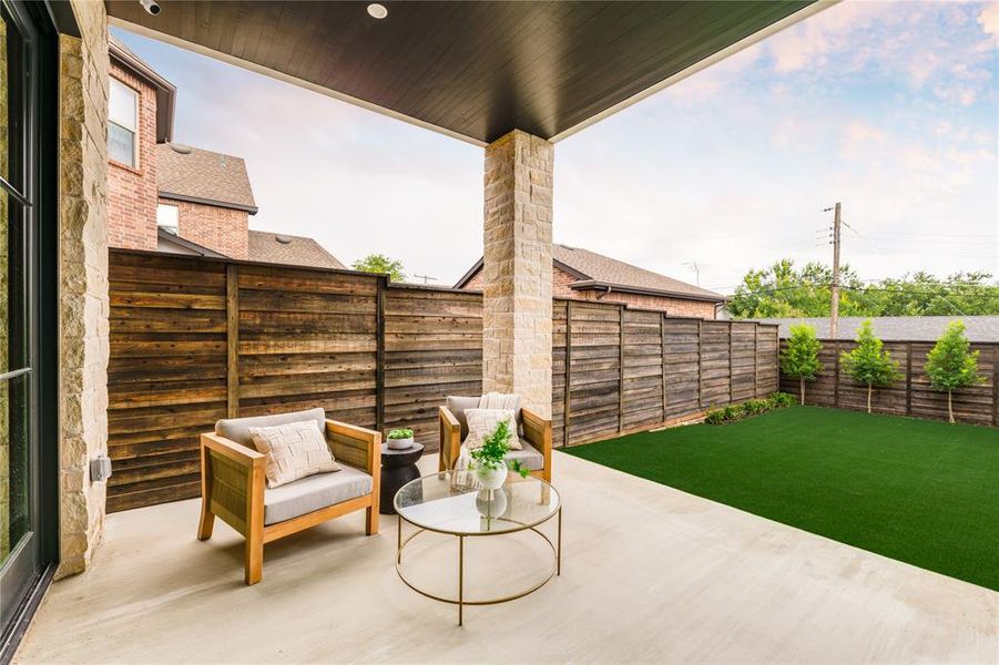 Fenced backyard with a patio