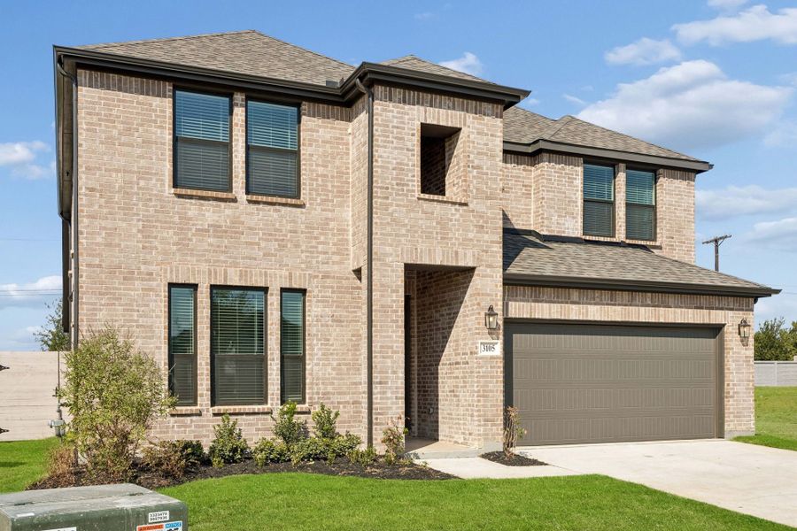 Front exterior of a new home in Painted Tree Woodland West, McKinney, TX, highlighting curb appeal (Image 19).