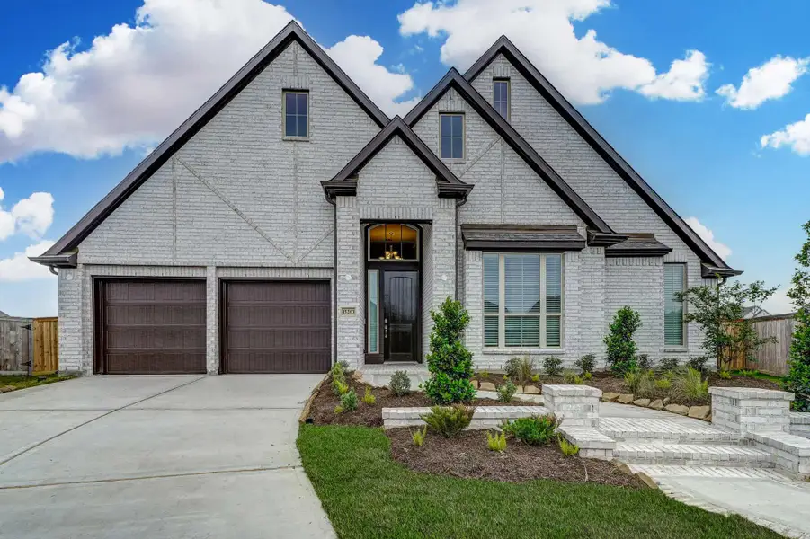 Representative exterior photo of a completed home built from the 3068 by Ravenna Homes in The Woodlands Hills 65′, Willis, TX (Image 25).
