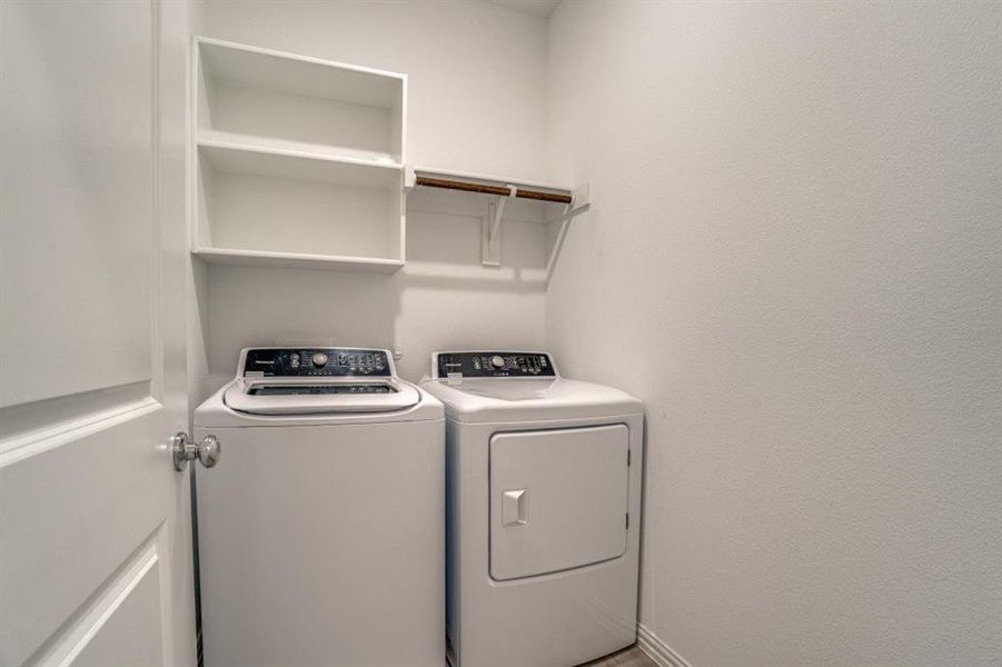 Laundry area with independent washer and dryer and baseboards