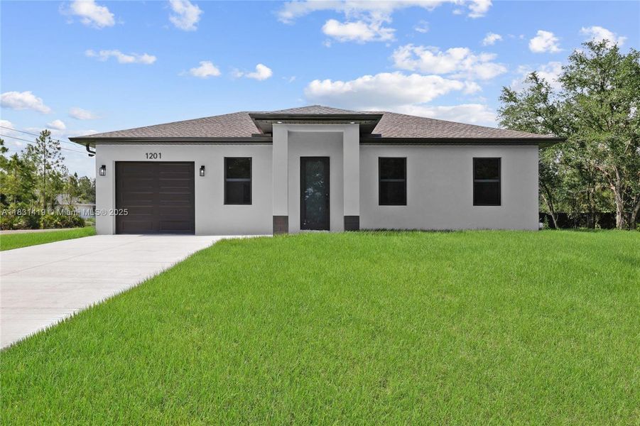 Front exterior of a new home in , Lehigh Acres, FL, highlighting curb appeal (Image 1).