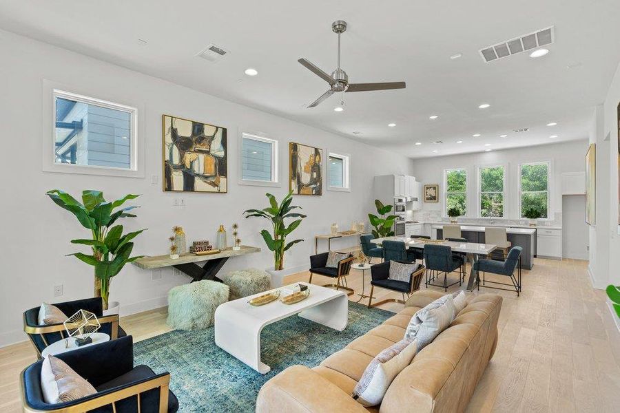 Expansive open-concept living and dining area with soaring ceilings, oversized windows, and upscale finishes throughout.