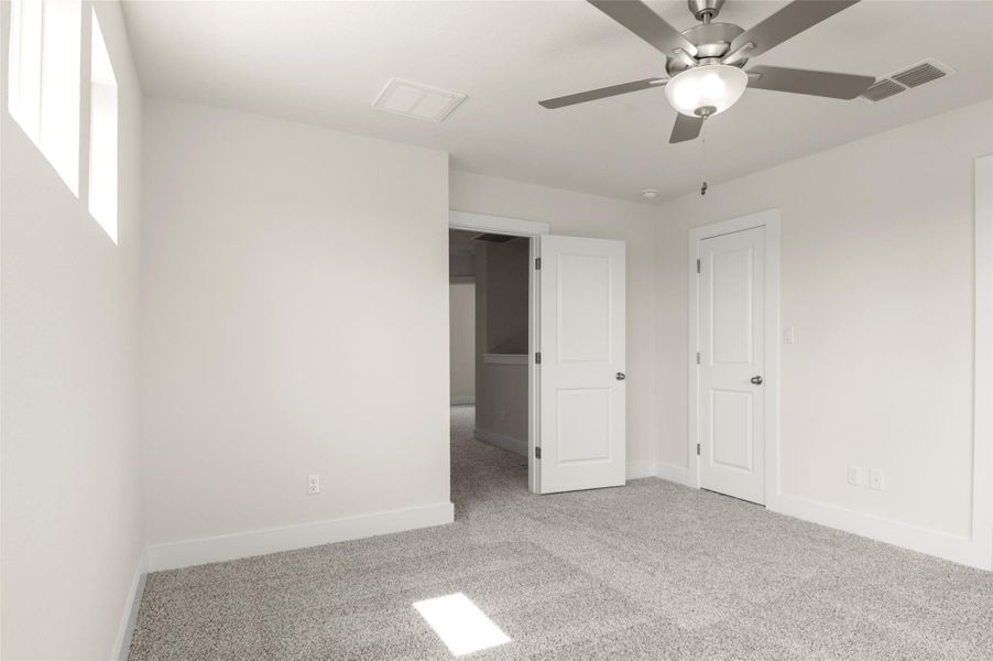 Unfurnished bedroom with visible vents, carpet, and baseboards