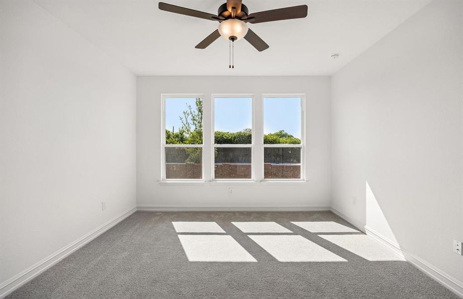 Primary bedroom with large windows