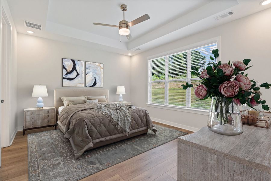 Spacious room featuring a tray ceiling, recessed lighting, and a contemporary ceiling fan Spacious room featuring a tray ceiling, recessed lighting, and a contemporary ceiling fan