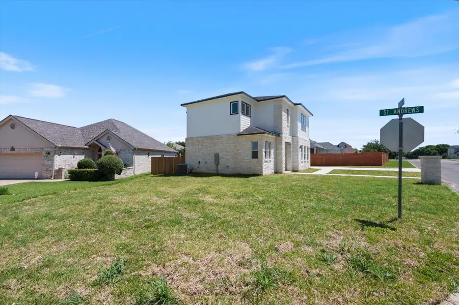 A well-maintained lawn introduces this charming residence with a stone and siding exterior.